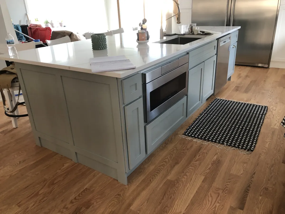 Kitchen with a greyish-green painted island